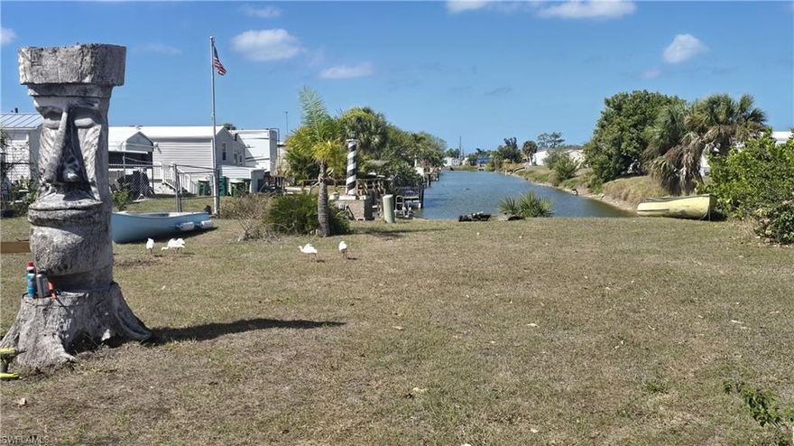 Amazing opportunity to own this truly affordable WATERFRONT home on a freshwater canal in this 55+ community where the HOA fees are a mere $315 annually. This charming home features a split bedroom floor plan with 2 bedrooms and 2 baths, newer dishwasher and washer & dryer, this turnkey home is perfect for entertaining or relaxing in the glassed in lanai. Watch gorgeous sunsets from your lanai with a long water view down to the tranquil Redfish Canal. There is abundant natural wildlife in the area, backyard fishing and a unique waterway ideal for kayaks, paddleboards, canoes as well as shallow boats. Meticulously maintained, this home can be your new retirement residence or your winter getaway. The Holiday Mobile Estates community nestled in Englewood offers many Clubhouse amenities including the heated pool overlooking the lake, tennis courts, pickleball, shuffleboard and more. This very special location is close to great shopping, restaurants from casual to gourmet and world class Golf Courses. Enjoy the relaxed atmosphere of artsy & quaint Olde Englewood Village, Sarasota cultural activities such as the Mote Marine Laboratory & Aquarium, the Ringling Museum, Sarasota nightlife and much, much more. Plus this location is just a 15 minute drive to Englewood Beach. This is the perfect spot to retire or just enjoy as a winter retreat in sunny Florida