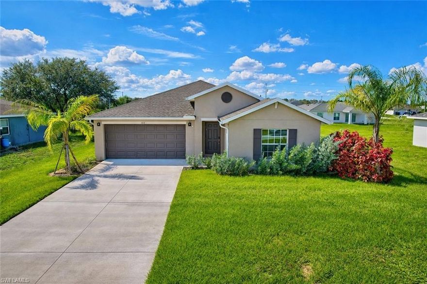 Welcome to this well-maintained single-story home located on a quiet street in Lehigh Acres, offering space, functionality, and a clean, move-in-ready interior. The open-concept floor plan creates a seamless flow between the kitchen, living, and dining areas, ideal for everyday living and entertaining. Neutral tile flooring runs throughout the main living spaces, enhancing durability and ease of maintenance.

The kitchen is designed with white cabinetry, quartz countertops, stainless steel appliances, and a large center island that provides additional prep space and seating while overlooking the main living area. Recessed lighting and ample cabinet storage complete the space.

The split-bedroom layout offers added privacy. The primary suite features a walk-in closet and an en-suite bathroom with dual sinks and a walk-in shower. Secondary bedrooms are well-sized and share a full bathroom with a tub/shower combination. Sliding glass doors lead to a spacious backyard with room to personalize, add a patio, garden, or future outdoor features.

Additional highlights include a two-car garage, indoor laundry, and a low-maintenance lot. No HOA restrictions. Conveniently located near major roadways with easy access to shopping, dining, schools, and daily necessities. A solid option for owner-occupants or investors seeking a newer-style home in a growing area of Lee County.