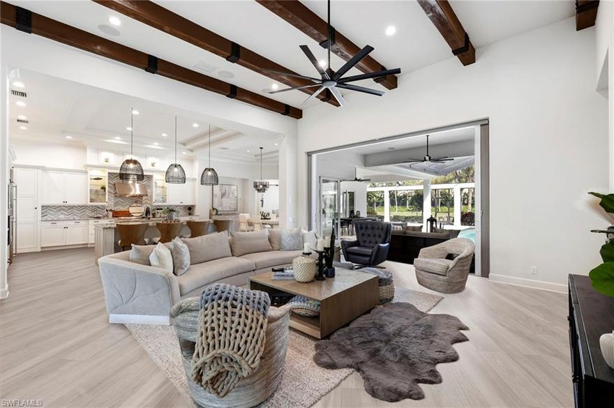 Discover the luxurious charm of Salerno at Miromar Lakes with this newly updated sanctuary, offering an unparalleled living experience. This impressive home spans 4,000 square feet and features 4 spacious bedrooms, 4 elegant bathrooms, a versatile den, and an additional bonus room, providing ample space for relaxation, work, and entertainment.

Every aspect of this residence has been meticulously designed with a focus on refined elegance and modern convenience. The heart of the home is the stunning double-island kitchen, equipped with gleaming stainless steel appliances and designed to inspire culinary creativity. The adjoining grand great room, adorned with rustic wood beams, enhances the inviting and warm ambiance, making it the perfect space for both quiet evenings and social gatherings.

The expansive bonus room, complete with a wet bar, offers a stylish setting for entertaining guests. It seamlessly connects to the large lanai area, creating an ideal flow between indoor and outdoor living. The outdoor space is a highlight, featuring an outdoor kitchen, a custom-designed pool, and a private boat dock along the tranquil lakefront. This serene setting invites you to enjoy leisurely water activities and breathtaking views, enhancing your outdoor lifestyle.

Modern conveniences have been thoughtfully incorporated, including a 240V electric car charging outlet and an air-conditioned 3-car garage, ensuring eco-friendly and comfortable living for your vehicles.

Conveniently located near Southwest International Airport, bustling shopping centers, and the renowned JetBlue Stadium, this residence combines luxury with practical accessibility. Miromar Lakes offers a comprehensive array of resort-style amenities, including pickleball and tennis courts, a marina, a state-of-the-art fitness center, and exquisite dining options. These amenities cater to a variety of interests and provide a lifestyle of exceptional leisure and enjoyment.

This home represents a unique opportunity to experience the epitome of Florida living. Don’t miss your chance to make this exceptional property your own. Welcome to paradise!