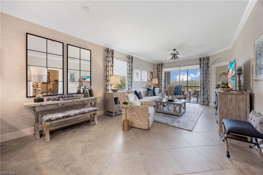 Stunning Designer Condo with Premium Upgrades and TPC GOLF MEMBERSHIP! Highly desirable and rarely available TOP/3RD FLOOR CELIANA END UNIT in the Acqua subdivision of Treviso Bay. No neighbors above! Beautifully renovated 2-bedroom + den, 2-bathroom condo, where every detail has been thoughtfully curated with designer finishes throughout. Step into luxury with completely remodeled bathrooms featuring sleek walk-in showers with frameless shower doors and high-end tile. A modern, upgraded kitchen that’s both stylish and functional. Highlights of the spacious kitchen include single-level island with quartz countertops, custom backsplash, stainless hood and a dry bar with an undercounter beverage refrigerator. This home is offered partially furnished with high-end pieces that complement the space perfectly. Custom window treatments and stylish wallpaper add a sophisticated touch, creating a warm and inviting atmosphere throughout. The versatile den provides the perfect space for a home office or 3rd bedroom. Enjoy magical sunsets from the tiled lanai overlooking the tranquil lake with a preserve view in the background. The property is situated adjacent to the satellite pool & grills. This active community features an 18 hole - par 72, Arthur Hills designed, championship golf course. Enormous clubhouse with full-service restaurant/bar, locker & card rooms, social activities room and well-stocked pro shop. Looking for a day away from the golf course? Treviso Bay has unmatched amenities, featuring: on-site spa/salon, fitness center with instructors and daily classes, 8 tennis courts, resort style pool with recently renovated poolside restaurant/tiki bar with daily happy hour specials, bocce, pickleball, and SO MUCH MORE. The 24-hour guarded; gated community is located approximately 5 miles from 5th Ave/downtown Naples which offers world class shopping & dining as well as some of the most spectacular sunsets you will find anywhere in the world. Move-in ready and effortlessly elegant—this condo is a rare find.