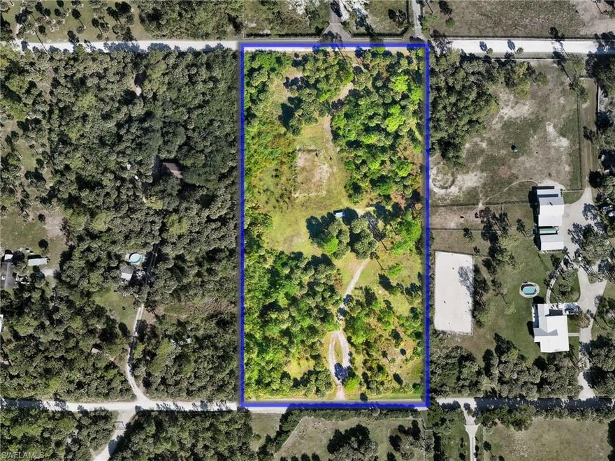 UTILITIES ON SITE – DUAL GATED ENTRANCES – FULLY FENCED LOT- WELL ON PROPERTY! This 5-acre Golden Gate Estates property is already prepped and ready for your vision, featuring permitted utilities, a well, and convenient gated access from both 28th Ave SE and Benton Road. The entire parcel is fully fenced for privacy and security, with most of the land already cleared and now covered with grass, creating an open and usable landscape. Both entrances include sturdy base-rock driveways, making access easy for vehicles, equipment, or future construction. A 50' x 90' elevated pad has already been installed for a future structure, and extra fill dirt remains on the property for additional grading or building prep. This is an exceptional opportunity to build your dream home or invest in a ready-to-develop lot in one of Naples’ most sought-after rural communities—no HOA, plenty of space, and total freedom to create the lifestyle you want. THIS PROPERTY QUALIFIES FOR A 1% LENDER INCENTIVE IF USING PREFERRED LENDER, INQUIRE FOR MORE DETAILS**