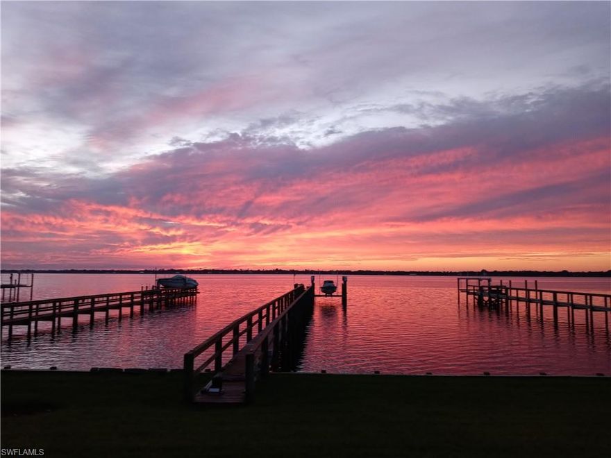 Discover a hidden treasure along the Caloosahatchee River in North Fort Myers. This spacious home features a deep-water dock, making it a dream come true for boating and water enthusiasts. From the moment you walk through the door, you'll be captivated by sweeping river views that bring the beauty of Southwest Florida right into your living space. The thoughtfully designed layout includes soaring ceilings and a generous den or office to the left, enclosed with elegant glass French doors. The kitchen overlooks the river and flows seamlessly into the dining area, where large windows frame the stunning scenery. This residence offers two master suites — one upstairs and one downstairs — providing flexibility and comfort for multi-generational living or hosting guests. The downstairs suite opens directly to the lanai, perfect for enjoying morning coffee or evening breezes. Significant recent upgrades enhance both value and peace of mind, including a new roof (Sept 2023), a top-of-the-line seawall (May 2023), new 2nd-floor carpet (Jan 2026), and a new epoxy-coated garage floor (Dec 2025). Additional features include impact windows and doors, plus accordion and roll-down shutters for added protection. A one-year home warranty covering major mechanical systems will be provided by the seller. Located just minutes from the Fort Myers River District and with easy access to I-75, this home combines tranquility with convenience. Located just minutes from the Fort Myers River District and with easy access to I-75, this home combines tranquility with convenience. Don't miss your chance — contact your agent today before this riverfront gem is gone.
