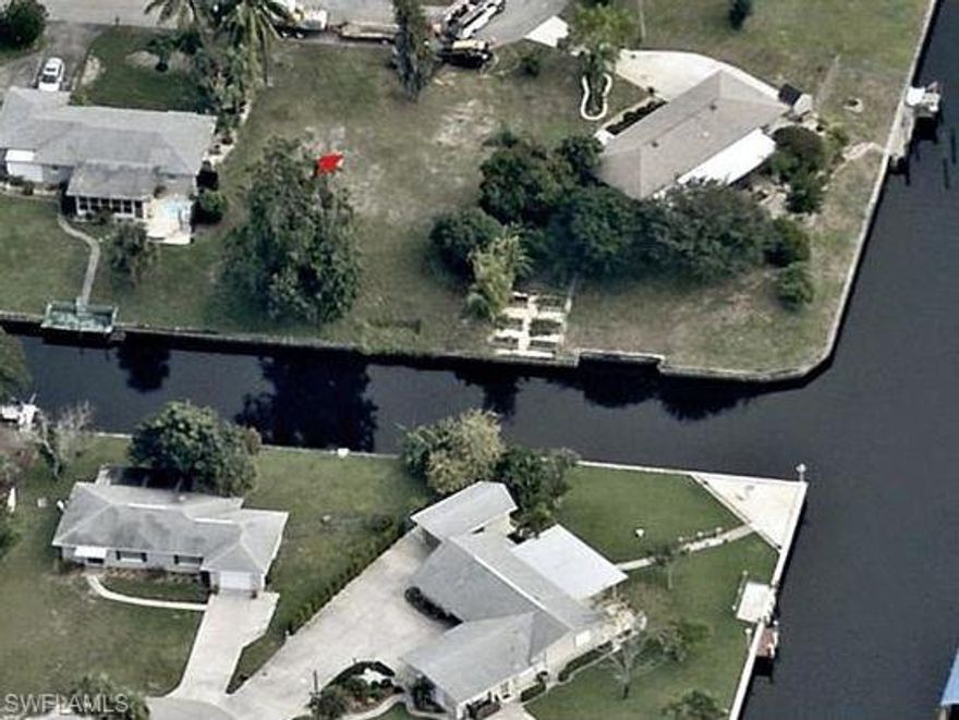 GULF ACCESS PROPERTY IN BOOMING NORTH CAPE CORAL.  SEAWALL IN PLACE