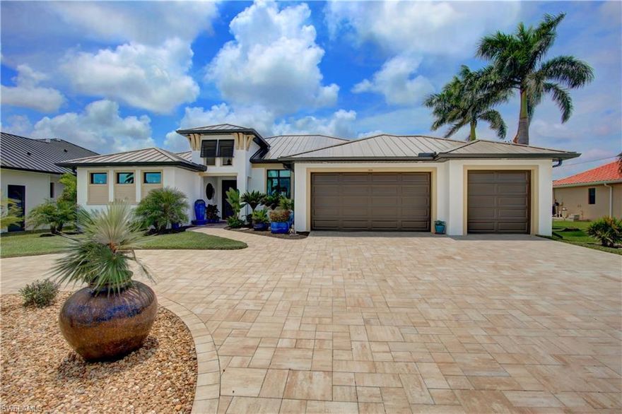 Buyer Canceled for Personal Reasons - Home is Beautiful and Ready to go! Unprecedented price point for this gorgeous, like-new, gulf-access pool home.  There's nothing in its highly desirable neighborhood that is newer/nicer for less! Built in 2022 and improved upon to be better than the day it was finished, you'll love this immaculate home. This home provides coveted southern exposure, ensuring your heated pool/sun-shelf enjoy full sun, year-round. Head towards the water and you’ll find a 60 ft paver captain's walk and a 40 ft wrap-around composite dock, complete with a large built-in table. The dock is spacious enough for a 30 ft + boat and offers water and electric hookups. Relax and soak in stunning sunsets from the built-in canal-front bench, adding a touch of tranquility to your outdoor living. Heading towards the home, you’ll notice a large covered, under truss, outdoor living area with ample space for all your entertaining needs. Inside, this residence offers 3 bedrooms plus a den/flex space that is currently used as a formal dining area, 2 baths (including a pool bath), and over 2,300 sq.ft. of living space under air. The home features a gorgeous new standing seam metal roof (installed in July 2024), a whole-house air purifier, and peace of mind from hurricane windows and sliders. The KitchenAid appliances, including an induction oven and convection microwave, enhance your culinary experience, while tile flooring throughout and stunning cabinetry and counters in the kitchen and baths add elegance. Some other noteworthy features include the master bath’s luxurious walk-through shower, the huge circular paver driveway leading to a spacious 3-car garage and the fully fenced yard is perfect for the 4-legged friends. Priced competitively, this is easily the lowest price for a pool home of this size and age in this sought after neighborhood. Don’t miss the chance to make this your dream home or a high-end vacation rental. For absolute convenience, furnishings are available for purchase, if desired.