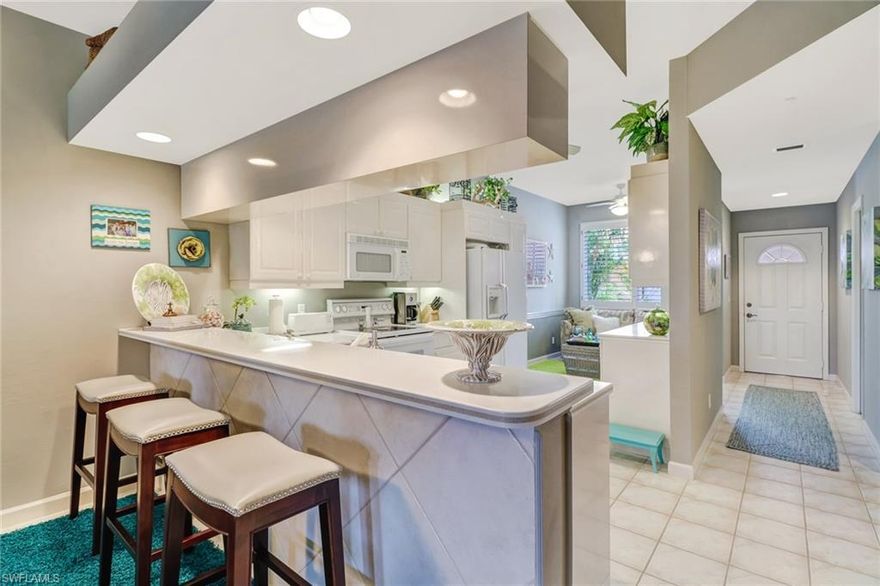 Beautifully kept 2 bedroom 2 bathroom condo (WITH GARAGE!) in the amenity rich Falling Waters Beach Resort community. Enjoy this oversized patios spacious backyard view through your opened sliding glass doors, steps away from your exclusive 600ft Lazy River Pool. Just UNDER 20 minutes to Naples Premiere Downtown 5th Avenue and the white sandy beaches of sunny SWFL, this condo truly offers the Naples lifestyle at an unbeatable price. Also featuring large clubhouse with a dance floor, library, big screen TV and kitchen, brick paver walkways & parking areas, and a shuffleboard court, tennis center, bocce ball court, and lap pool. Schedule your showing now as this condo was priced to sell and won't last long!