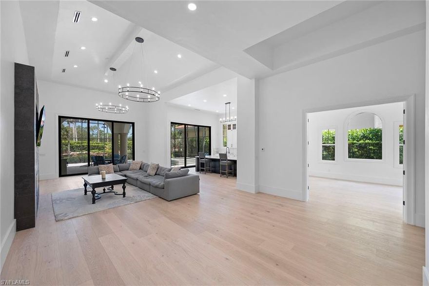 AVAILABLE furnished or unfurnished ANNUALLY or for 6+ MONTHS.  Located in the gated, prestigious North Naples community of Norman Estates in Tiburon, you'll be the first to enjoy the stunning changes and upgrades made to this 5 bedroom + den pet-friendly home. All of the living space is located on the first floor with the exception of two guest bedrooms and a full bath on the second level.  Enter the home through the oversized two-car garage or the charming courtyard, and you'll see soaring ceilings making the Great Room look even more grand. The kitchen is truly set up for entertaining with an island bar, tons of storage and sliding glass doors to the screened lanai lending itself to pool side beverage service as well as preparing meals at the outdoor kitchen / grill area. There is ample space in the Great Room to establish a formal or informal dining area or to set up several seating areas for cocktails or cards.  The first floor Primary Bedroom Suite has its own foyer area and two walk-in closets separating the bedroom itself from the gorgeous spa-like bath. Beautiful windows offer views of the gorgeous landscaping by day and the lit swimming pool by night. The heated and screened swimming pool/hot tub enjoy lovely afternoon sun and sunsets. A second bedroom suite with a full bath is located near the front of the house near an additional half-bath. Den access is through double glass doors and affords a view of the charming courtyard shared with the detached Guest House/Cabana with its own kitchenette and full bath. Two second-floor guest bedrooms each have an open balcony and share a full bath. This home is available unfurnished or furnished for 6+ months and your well-behaved pet is welcome.