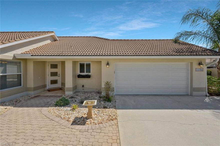 One or more photo(s) has been virtually staged, AI generated or rendered.  Nestled in the heart of Naples, this exquisite property offers a serene retreat in the private and secluded gated community of Longshore Lake.  A Palm Springs vibe permeates this residence, with all big-ticket renovations thoughtfully completed, NEWER AC, IMPACT WINDOWS & DOORS, NEW GARAGE DOOR ensuring both style and security. The home boasts a freshly painted interior and exterior, with an UPDATED KITCHEN & BATHROOMS featuring stainless steel appliances. Step outside to find a spacious lanai with a pool and spa with travertine decking, complemented by an additional water feature, perfect for relaxation or entertaining guests. Low-maintenance landscaping and a multi-zone irrigation system make it easy to enjoy the lush surroundings and create your own tropical oasis. Residents will appreciate access to community amenities such as a clubhouse with dining, a resort-style pool, a fitness room, and tennis courts, with pickleball courts coming soon. Ideally positioned, this home is just minutes from shopping, dining, and grocery stores, and a short drive to the renowned white sand beaches of Naples, offering the perfect balance of tranquility and convenience.