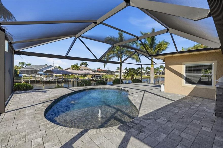 Easy Gulf Access! This exceptional canal-front home is a true boater’s dream, situated on a wide canal to the Caloosahatchee River. Conveniently located just off Del Prado Blvd, you’ll enjoy easy access to shopping, dining, and everyday essentials while still tucked into an established neighborhood with mature landscaping.

This move-in-ready home features on open floor plan and has been thoughtfully renovated and upgraded throughout. The spacious kitchen is a chef's dream and boasts an open design with ample counter space,a GE Café gas range and microwave and custom copper sink. The master bedroom's highlights are the double closets and access to private patio with hot tub.

Step outside to your private waterfront oasis featuring a newly constructed dock and 13,000 lb boat lift with canopy, a resort-style heated saltwater pool with Pentair IntelliCenter system, sun deck, bubbler, bench seating, dual water features, and a reinforced screened enclosure. Entertain with ease in the outdoor kitchen equipped with Bull appliances, relax in the spa/hot tub, or enjoy shaded comfort under the electric retractable awning. A fenced yard, widened driveway, custom front doors, and updated bathrooms add to the home’s appeal.

Additional peace of mind comes with a newer roof featuring GAF architectural shingles and city water and sewer service. This triple-lot property offers space, privacy, and the ultimate Southwest Florida waterfront lifestyle—schedule your private showing today!