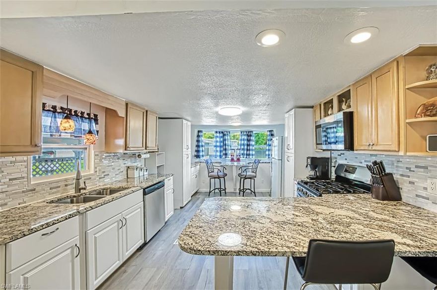 Best Lot in the neighborhood with a view! Gated hidden gem that is now walking distance to Sudgen Park! LOCATION! LOCATION! LOCATION! Enjoy the spacious and private lot that comes with this 2 bedroom 1 1/2 bath manufactured home in the active 55+ community of Moorhead Manor. Located close to Celebration park, The Botanical Gardens, and within walking/biking distance to NPC- Naples Pickleball Center. This home boasts a large kitchen with granite countertops and two breakfast bars. This home was professionally remediated after IAN. There are lots of activities for owners including: Shuffleboard, a recreation hall which has a laundry room, library, pool table and and area for crafts, and a community pool. This community offers low monthly HOA fees which includes: trash removal, water, sewer, lawn care and internet. You will enjoy the lifestyle this community has to offer. Come take a look and call Moorhead Manor home.