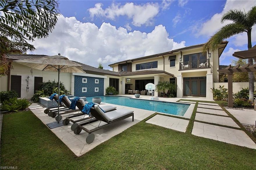 This prominent Naples address designed with a West Indies inspired feel exudes easy living and effortless entertaining. The open design creates an unmatched ease of living throughout, effortlessly connecting indoor and outdoor spaces, perfect for entertaining. Homeowners will appreciate the loft-style two-story great room along with a first-floor master suite, complete with a uniquely designed tub and shower along with a spacious dual closet. This home also offers three modern guest bedrooms and four-and-a-half guest baths, along with a sizable three-car garage. The well-appointed kitchen includes a working island, wine cellar and professional grade appliances that will inspire your inner chef. The unique outdoor area features a fabulous custom water wall and fountain display, summer kitchen, fire table and trellised seating for relaxing. The Moorings, an idyllic location in Naples, also offers residents eligibility to apply for membership at the Moorings Country Club and private beach access. Located close to Waterside Shops, Venetian Village and downtown Naples, this is where you want to live.