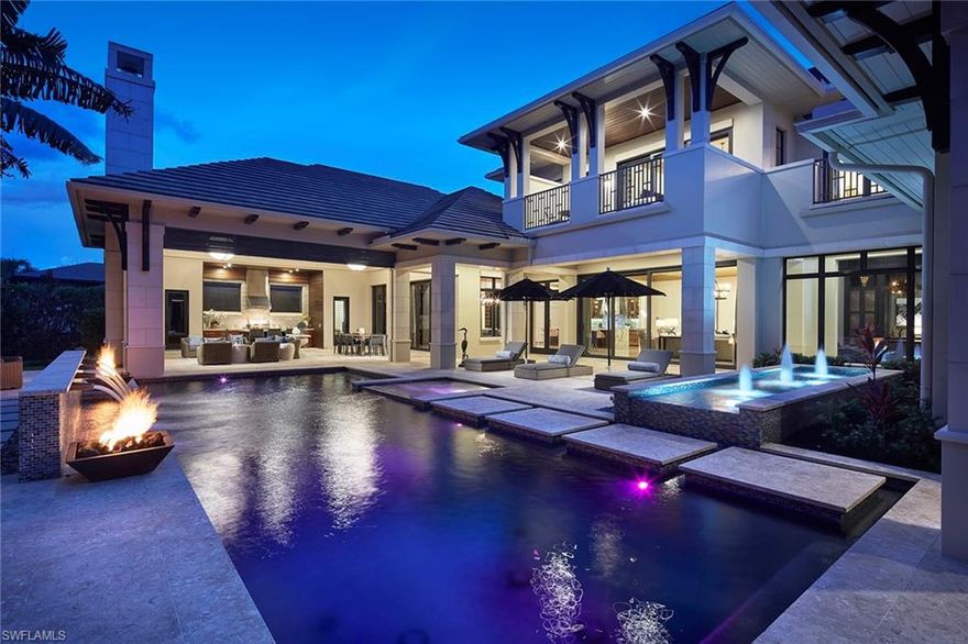 Immediate full golf membership eligibility. This stunning clean-lined former Stock Custom Homes model resides on a private .71-acre homesite and is being offered turnkey furnished. The over 7,700-square-foot estate features five bedrooms, five full and two half baths, study, club room and second floor loft. This home lends itself to entertaining family and friends including an open great room plan adjacent to an oversized club room with wet bar and opens to the spacious lanai. Enjoy Naples mild climate and outdoor living featuring a gas heated pool and spa, fire bowls, gas fireplace and a sizeable, covered lanai with intricate wood ceiling, all enclosed at the touch of a button with automated screens and hurricane shutters. Guest bedrooms are en suite including a first floor private VIP retreat with morning bar ideal for guests or a live-in family member. Additional features include an attached four-car garage, impact windows and doors, whole-home natural-gas generator, elevator, Wolf and Sub-Zero appliances and climate-controlled wine room. A world of luxury awaits you within the updated Grey Oaks Country Club community minutes from world-class amenities of Old Naples.