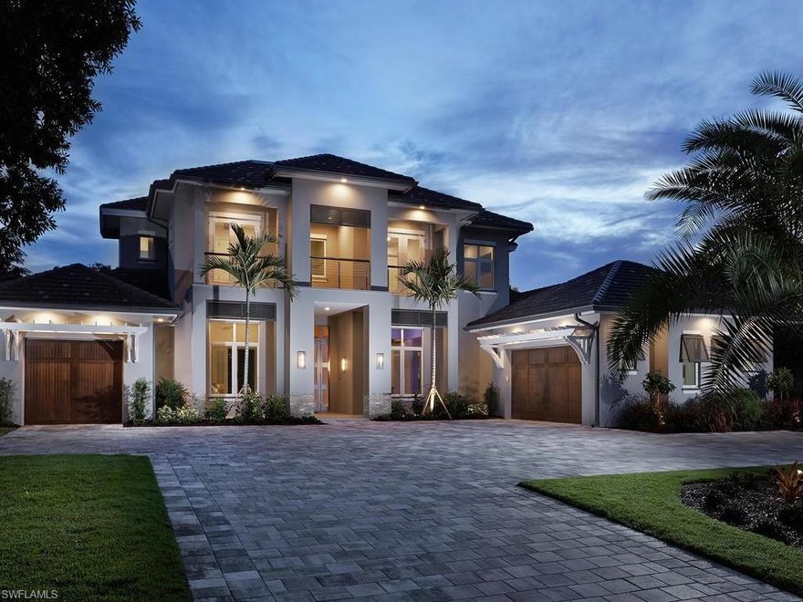 SAND DOLLAR AWARD WINNER!!! Stunning Modern Transitional masterpiece, on one of the most desirable streets in the Moorings! This exquisite home has been beautifully furnished and the wide-plank wood floors, accentuate the architecture. This magnificent custom home features 4735 square feet under air, 4 Bedrooms, 4 1/2 Baths, Great room w/linear fireplace, den/office, bonus room, (2) laundry rooms, large kitchen with custom cabinetry, (2) Islands, wet bar, top of the line appliances, and Control 4 Smart-Home lighting, sound, and security technology. A custom, floating staircase with stainless steel and cable railings, and glass enclosure, frame the brick-walled Wine Room. The spa-inspired Master bath includes; warm walnut floating vanities, white glass wall tiles with pearlized glass accents, and unique concrete style tile flooring. The Out-door Living area boasts approx. 1000 sq. ft. of additional Florida living with a brick-wrapped fireplace, including outdoor kitchen with refrigerator, gas grill, and ice-cooler. A custom oversized gas heated pool and spa, with beautiful fire bowls, capture the sun for most of the day, and make this the  perfect home for entertaining.