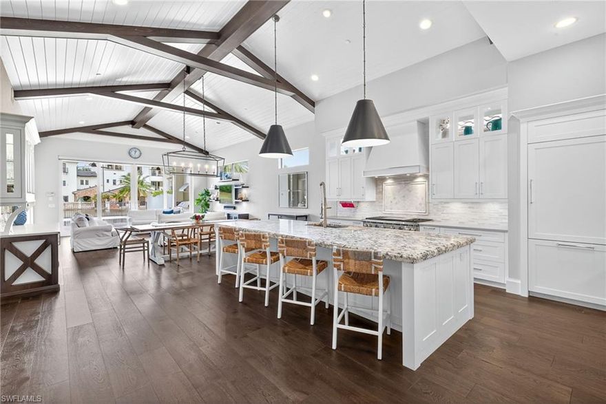 LIVE YOUR BEST LIFE in this gorgeous FURNISHED TALIS PARK residence on Watercourse. A magnificent home offering 3638 SF of air conditioned comfort, a 2 1/2 car garage (room for your golf cart), three spacious bedrooms, a handsome office, rich hardwood flooring and four full baths! The gourmet kitchen provides upgraded cabinetry, an expansive island, natural gas, a Wolf range with a double oven, a Fischer Paykel dishwasher and a Gaggenau refrigerator. The summer kitchen and infinity edge saline pool/spa are welcoming areas to enjoy breathtaking sunsets and entertain with ease while overlooking the Venetian style lake. The second floor features two ensuite bedrooms/baths with walk in closets and a spacious loft area. A sophisticated main floor primary suite with a luxurious bath, spa like shower, two water closets and a generous walk in closet is truly resplendent. Recent upgrades/additions include a whole house Generac generator, a whole house water softener, a tankless hot water heater, Culligan reverse osmosis system and new S2 Sonos speakers. Talis Park is an award winning community with an active social calendar year round. The Greg Norman/Pete Dye designed golf course, numerous dining venues, fitness center, tennis, pickleball, bocce, two dog parks and miles of beautiful walking/biking areas make this community a "must see." Located in North Naples and a perfect in between distance to RSW Airport and downtown Naples as well as the beautiful Gulf beaches.