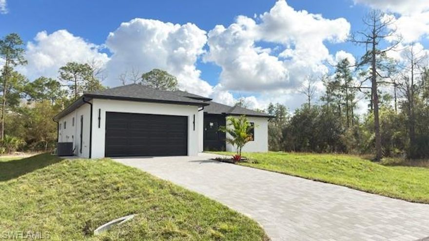 Impressive 2026 new home on .50 acres, crafted with upgraded features and stylish finishes throughout. Metal Impact double entry doors, pavers driveway and 
entry, open floor plan, lots of natural light, modern light fixture and fans. Beautiful kitchen with stainless still 
kitchen hood, white quartz countertop with a waterfall/island, wooden 42" cabinets with crown and light 
molding, stainless still appliances, cooktop stove and Dual Microwave/Oven. White porcelain tile flooring 
24x48 throughout the entire home. Living room fireplace. Walking closet in the master bath, double sink, 
Shower panel tower system rain and waterfall massage jet sprayer and both showers with glass doors and 
panels. A/C with returns in each room for a better A/C circulation. Ceiling fans in each bedroom and the 
living room. 10' Celling with crown molding, 8' Interior doors. Impact windows and doors. Completed 
outdoor kitchen. Sprinkles system and more.