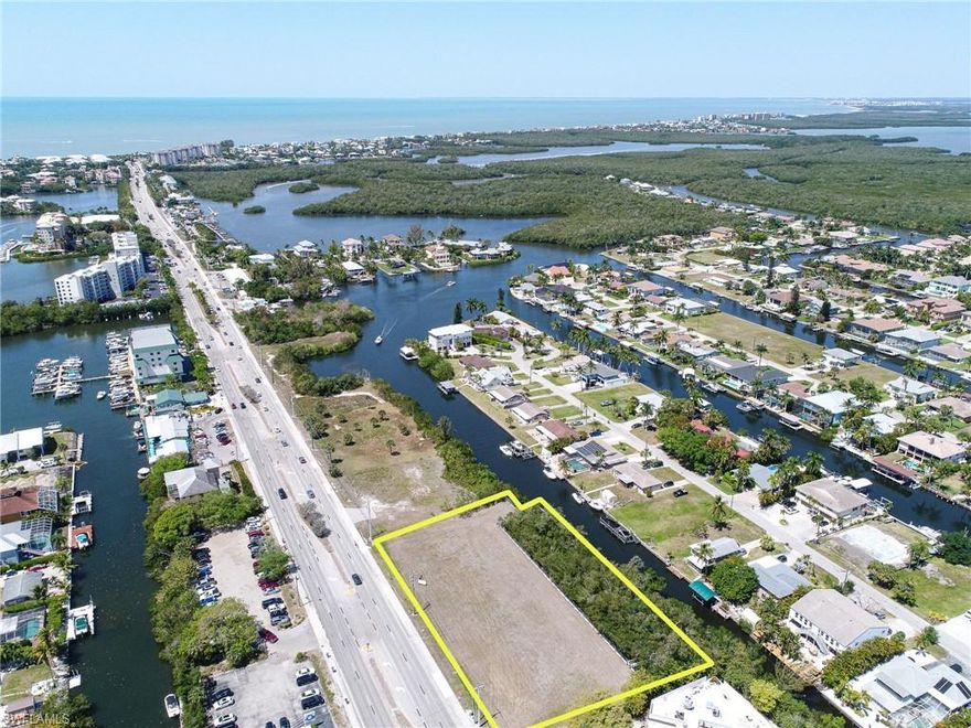 This 1.5 acre waterfront C1 commercial land on Bonita Beach Road offers walking or biking to Bonita Beach and premier boating. This filled and ready-to-build property features a 250’ Dock with two access ramps and 400’ of seawall. Gulf access available via canal then north via New Pass or south via Wiggins Pass.  2021 City of Bonita Springs Traffic Count Study, Zoning verification letter and C1 Zoning permitted uses are attached and available.  C1 zoning offers conversion to residential possibilities.  New survey with topographic attached and available.