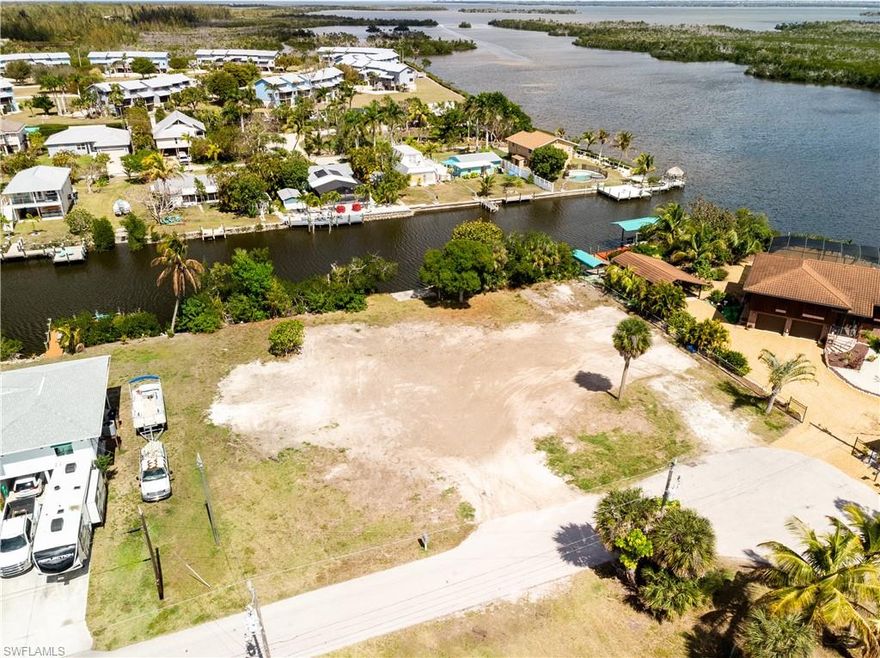 THIS IS A RARE FIND... 1/2 acre+ waterfront homesite in Bokeelia. HUGE gulf access lot, 170+ feet canal frontage, zoned RM-2 with impact fees paid.  Minutes to Charlotte Harbor. Fantastic views of waterways and preserve. With so much room the options are endless.