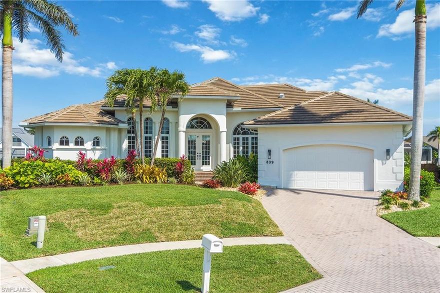 This beautifully maintained home with modern updates and finishes is located on a 171' wide tip lot with both northern and southern water views sits at an impressive 11.1' NGVD elevation. Located in a prime neighborhood on a peaceful cul-de-sac ideal for evening sunset views. This home features 3,015 square feet of indoor living space, high volume ceilings, three bedrooms, three full bathrooms and a large front office. The master suite includes his and her walk-in closets and a spacious bathroom. There is lanai access and water views from almost every room in the home including wide panel sliding glass doors for seamless indoor/outdoor living. The oversized sliding doors fully open into a large, covered lanai, heated pool area and ample space for outdoor dining. This home is in an ideal location for boating and fishing with a short boat ride to the ocean, as well as a short bike ride to local restaurants, shops, and Resident's Beach.