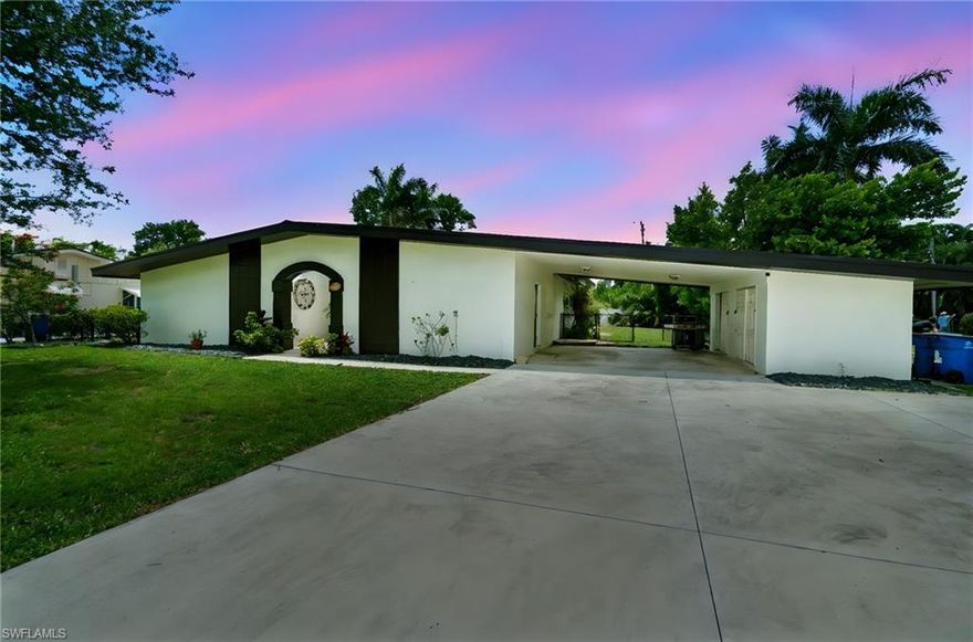 Discover this stunning 3-bedroom, 2-bathroom modern farmhouse, offering 2,118 square feet of thoughtfully designed living space on a spacious .362-acre lot filled with lush landscaping and swaying palm trees. This private retreat seamlessly blends style, comfort, and functionality, making it the perfect place to call home. Inside, an expansive open floor plan greets you, with natural light pouring in through a skylight above the living room to create a serene ambiance, ideal for relaxing evenings. The heart of the home is the dream kitchen, featuring a large island with plenty of storage, a striking copper farmhouse sink, and high-end café appliances. The kitchen effortlessly connects to the rest of the living space, allowing for easy entertainment and everyday convenience. The spacious dining room is designed to accommodate festive family gatherings or entertaining friends, and the entire layout is enhanced by a durable and stylish metal roof for peace of mind. Step outside to your own outdoor paradise, complete with an oversized saltwater pool, expansive patio space, and a vast backyard, offering ample room for kids and pets to play or for hosting memorable get-togethers. Practical amenities include an attached 2-car carport with a versatile laundry area and additional storage or workshop space. The generous primary suite features a walk-in closet, dual sinks, and a luxurious glass-walled shower, offering a spa-like experience at home. Two guest bedrooms, separated by an updated bathroom with a soaking tub, ensure comfort and privacy for family or visitors. Located just minutes from College Pkwy and Colonial Blvd, this modern farmhouse is close to top-notch dining, shopping, and all of Southwest Florida’s vibrant entertainment. Offering a unique blend of functionality and elegance, this home invites you to make lasting memories and enjoy the Southwest Florida lifestyle to its fullest. Come see for yourself all that this breathtaking home has to offer!