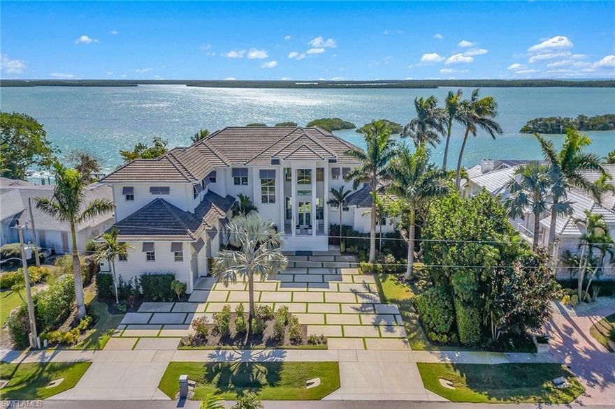 One of the captivating homes available on Marco Island. The grounds offer a welcoming air that sets the tone for what this home offers: a luxury waterfront retreat in the prestigious Estate section of Marco Island with dramatic exposures of Caxambas Pass out to the Gulf. This incredible home was masterfully built in 2020 by Ross Tackett, designed by Bill Lewis and offers a distinctive twist on classic coastal design by incorporating timeless finishes with livable spaces, copious amenities and a sensible floor plan creating an escape that is as stylish as it is comfortable. Offering 7,000-plus air-conditioned square feet over two-levels with six bedrooms plus den, eight-and-a-half baths, theatre room and more all exquisitely designed and furnished throughout. Each suite is complemented by its en-suite bath for ease and comfort. Tranquil water views can be found from nearly every space. The outdoor living areas enhance the entire property with over 3,000 square feet of lanai/outdoor terraces. Beautiful saltwater pool/spa, outdoor kitchen and multiple seating areas where you can entertain guests or simply unwind and take in the beauty of the nature you are surrounded by. This half-acre, southern exposure lot with 125 feet of water frontage is seated amid spectacular scenery of the pass, 10,000 Islands, area wildlife and colorful skies. Private, direct access deep-water dock outfitted with two slips and two wave runner lifts, only minutes to all that make Marco Island a world-class destination. Whole-home generator. Elevator. New seawall in 2020. Buried propane tank. Impact glass doors/windows. Spacious garage with epoxy floors, three stalls with ability to have lifts to accommodate at least four cars/small RV/sprinter. Today's luxury homebuyers want reality, not promises. They want something special and ready to enjoy today, so welcome home.