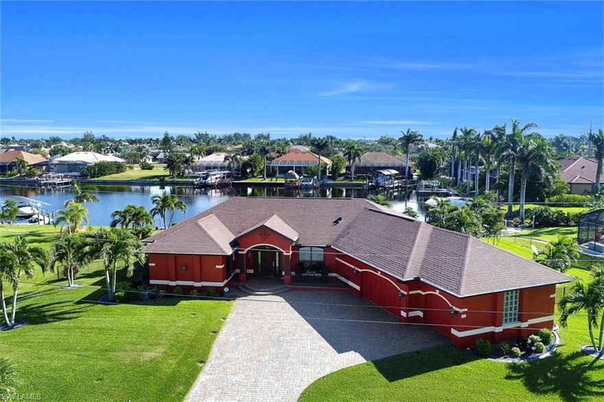 This home is located in one of the Cape's best neighborhoods, on one of the best lots in the town! The lot is over 20,000 square feet with 135 feet of seawall overlooking an extra large gulf access canal. The home is perfection in and out! From the huge pavered brick driveway to the enormous garage (over 800 square feet) with epoxy coating. The home was completely rebuilt with no expense spared- does not seem like a 1995 home in any way. The roof has a secondary water barrier, &  the windows are impact.  The kitchen features beautiful wood cabinets, stainless appliances & granite counter tops. All flooring is hard surface, no carpeting! There are three bedrooms and two dens-one large enough for a baby grand piano! There are custom built ins and beautiful window treatments. The outdoor area is amazing. Huge pool area with picture window screens and a tiled lanai and pool deck.  Plenty of space for entertaining while overlooking one of the widest canals in Cape Coral. Currently a purple martin sanctuary- hoping for another bird lover to enjoy watching them swoop in and out of their home. Great water access, all assessments paid and so much more. Come see for yourself.