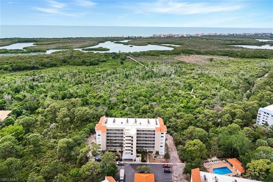 Coastal convenience meets effortless Florida living in this beautifully maintained first-floor condo, ideally located west of US-41 and only minutes from the Gulf's most desirable beaches. With ground-level entry and no stairs or elevators to navigate, this residence offers easy everyday access and exceptional comfort. Inside, the thoughtfully designed split-bedroom floor plan features 2 bedrooms and 2 full baths, creating privacy and flexibility for guests or family. The spacious screened lanai offers a tranquil setting to enjoy your morning coffee or unwind after a day in the sun. Offered partially furnished, this move-in-ready property is perfect as a full-time residence, seasonal getaway, or investment opportunity. Situated near Wiggins Pass, you'll enjoy close proximity to Barefoot Beach, Delnor-Wiggins Pass State Park, shopping, dining, and all the best of North Naples. Residents of this gated community enjoy resort-style amenities including a clubhouse, community pool, walking paths, pickleball, and tennis courts. Whether you're searching for a relaxed coastal retreat or a smart investment in a prime location, this condo delivers the ideal Naples lifestyle.