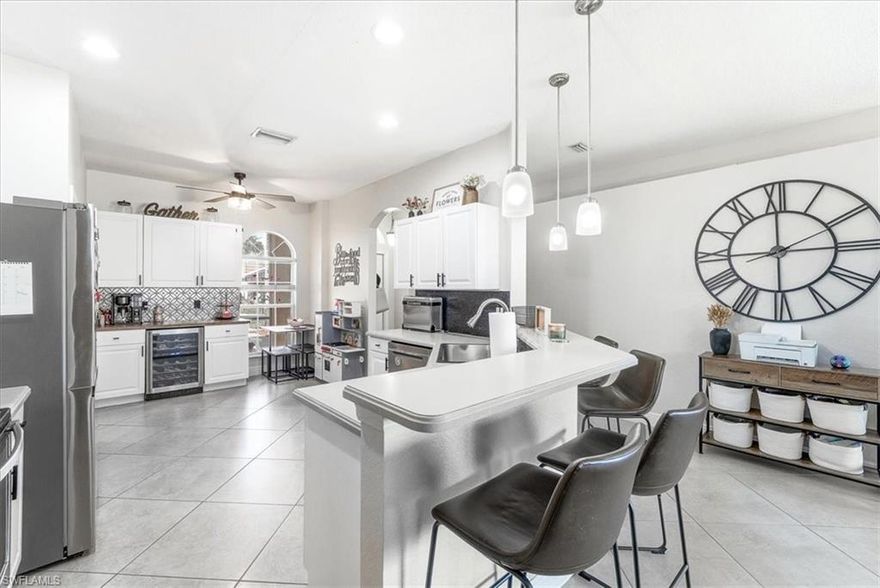 Discover this move-in ready home in the sought-after gated community of Stoneybrook at Gateway! This beautifully updated 3-bedroom, 2-bathroom residence offers 1,561 square feet of thoughtfully designed living space with upgrades around every corner. Step inside to find an open-concept layout featuring tile throughout, a split floor plan, and a charming coffee/wine bar perfect for entertaining. The primary suite offers direct lanai access, a walk-in closet, and a spa-inspired bathroom with dual sinks, walk-in shower, and a luxurious soaking tub. Major updates include a new A/C, roof, water heater, irrigation panel, and gutters — giving you total peace of mind. The outdoor space is where this home truly shines. Enjoy serene lake views from your backyard, which offers plenty of room to add a pool. The lanai provides the perfect setting for catching those legendary Florida sunsets. Stoneybrook at Gateway is one of the most inviting communities around, featuring seven lakes, walking and bike paths, and an incredible amenity center. Residents enjoy a heated pool, spa, kiddie pool, fitness center, basketball and tennis courts, pickleball courts, a volleyball court, hockey rink, soccer field, and baseball field — plus a children's playroom, library, and game room. The location is unbeatable — just minutes from JetBlue Park, Southwest Florida International Airport, Publix, Top-Rated Schools and Bell Tower's shopping and dining!