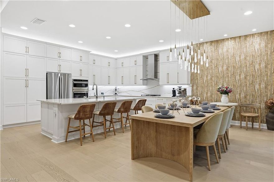 Welcome to this extensively upgraded Captiva model in Valencia Trails offering 4 bedrooms plus a club room, 4 full baths, and approximately 3,176 sqft, with a 3-car garage and an extended screened lanai. Designed for both elevated everyday living and seamless entertaining, a spacious great room with coffered ceiling and thoughtfully designed gourmet kitchen opens to the main living spaces. The kitchen features upgraded cabinetry, quartz countertops and backsplash, under-cabinet lighting, and GE Profile stainless steel appliance package, including wall oven, microwave, and chimney-style hood. The primary suite offers dual walk-in closets and a luxurious bath with dual sinks, separate tub and walk-in shower. Each additional bedroom is generously sized with access to its own full bath and upgraded with frameless shower enclosures, offering comfort and privacy for guests, while the dedicated club room provides flexibility for a media room or home office. 

This home reflects a significant investment in both visible design and behind-the-scenes upgrades. Engineered light oak hardwood flooring extends throughout the main living areas and bedrooms, enhanced lighting, and elevated finishes throughout the kitchen and baths. The cohesive design palette creates a sophisticated, move-in-ready aesthetic that reflects intentional investment and attention to detail. The HVAC system was upgraded to Carrier Infinity Series that is beyond builder standard specifications for enhanced efficiency and long-term performance. Additional mechanical and structural enhancements include impact glass throughout, tankless hot water heater, whole-house electrical upgrades, recessed LED lighting, and upgraded lighting fixtures.

The outdoor living experience is exceptional and represents a significant upgrades. The custom pool and spa includes an enlarged footprint, a raised negative-edge spa, therapy jets, upgraded pump systems, saltwater chlorination, auto-fill, 400,000 BTU gas heater, and multiple colored LED lighting features throughout the pool, spa, and sun shelf.  A fully equipped custom outdoor kitchen with built-in gas grill, refrigeration drawers, granite countertops, and ample prep space rounds out the space for true year-round living.

Select furnishings will be negotiable pursuant to a detailed inclusion and exclusion list, providing flexibility for buyers seeking a turnkey opportunity.

Living in Valencia Trails means embracing one of Naples’ premier 55+ resort communities. Residents enjoy a spectacular clubhouse with restaurant and bar, resort-style pool with cabanas, state-of-the-art fitness center, tennis and pickleball courts, bocce, card rooms, social clubs, walking paths, and a vibrant calendar of events that fosters connection and active living. The gated setting offers privacy and security while remaining conveniently located near Naples’ beaches, dining, shopping, and cultural amenities.