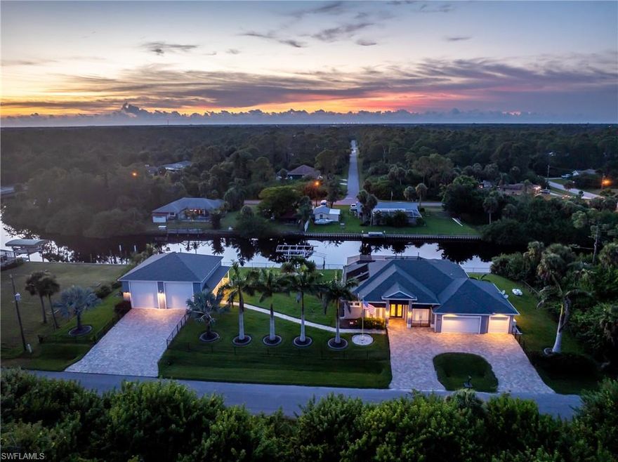 Built in 2019, this FULLY FURNISHED nearly new custom estate is a rare waterfront masterpiece offering the space, privacy, and luxury that are almost impossible to find. Situated on over 1.15 acres across five combined lots, including multiple oversized waterfront parcels and additional buildable lots across the street, this property delivers unmatched value, flexibility, and long-term potential. Set along 240 feet of pristine waterfront, the home features three docks, including one with a 10,000-lb boat lift and two additional docks ready for expansion. Inside, the residence showcases soaring 12-foot ceilings, dramatic custom wood entry doors, and expansive zero-corner sliders that open to sweeping water views and seamless indoor-outdoor living. The designer kitchen is a true showpiece, featuring a Sub-Zero refrigerator, premium appliances, elegant stone surfaces, and refined finishes throughout. The luxurious primary suite offers serene pool and water views, a spa-inspired bath with Roman shower and clawfoot soaking tub, and a custom California closet with direct access to the laundry room. Step outside to your private resort-style oasis—complete with a screened lanai, cedar plank ceilings, LED-lit heated saltwater pool, waterfalls, and a fully equipped stainless outdoor kitchen perfect for entertaining year-round. Additional highlights include a 3-car attached garage, a massive 40x40 detached garage with 16-foot ceilings and RV hookups, whole-house generator, electric hurricane shutters, and smart home features throughout. Located just minutes from dining, shopping, and Gulf beaches—with no flood damage, no storm impact, and no compromises—this is a rare opportunity to own a nearly new, estate-style waterfront home with unmatched land, privacy, and versatility.