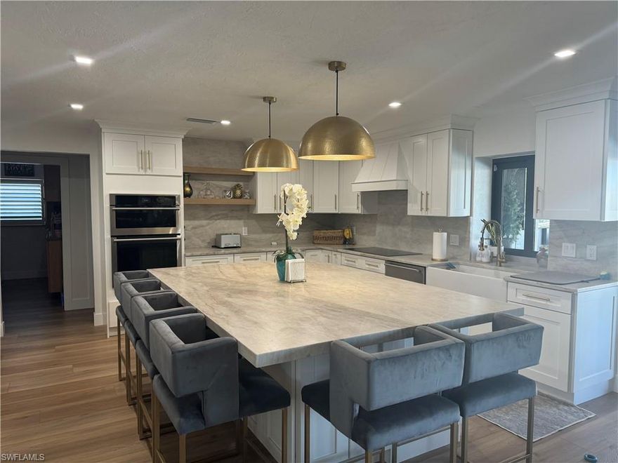 Welcome to this stunning four-bedroom, two-bath, completely remodeled sailboat-access home located in desirable Southwest Cape Coral, just minutes from Tarpon Point Marina, premier shopping, dining, and top-rated schools.
Situated on a three-lot site with no bridges to the river, this property offers direct, unrestricted access to open water—perfect for boating enthusiasts. The home showcases numerous high-end upgrades, including custom closets, luxury vinyl flooring throughout, plantation shutters, natural stone countertops in the kitchen, top-of-the-line appliances,impact windows/sliders, & security cameras. 
The open great room layout is ideal for entertaining, seamlessly flowing to the exceptional outdoor living space. The expansive lanai is truly one of a kind, creating the perfect setting for relaxing or hosting gatherings while enjoying the waterfront lifestyle.
Complete with a 10,000-pound boat lift, trex decking wrap around dock, this home places you just minutes from open water and delivers the best of Southwest Florida living—whether year-round or as a luxury retreat.