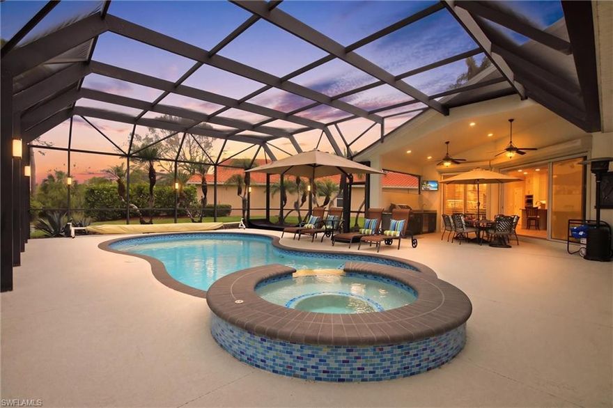Enjoy easy, vacation-style living in this beautifully updated single-family pool home within the bundled golf community of Naples Lakes Country Club, where maintenance-lite living and full amenities let you focus on enjoying Naples. Inside, soaring ceilings with tray detailing create a bright, open feel, complemented by updated 8x48 plank tile flooring throughout the main living areas. The kitchen has been thoughtfully redesigned for both everyday use and entertaining, featuring high-level granite countertops that extend seamlessly to the outdoor summer kitchen, custom shaker cabinetry with updated hardware and upper and see-through cabinets, and a redesigned peninsula lowered to 36” counter height for a more comfortable, casual layout. Stainless steel appliances complete the space while keeping the look clean and cohesive. Set on a rare end-of-cul-de-sac tip lot, the home offers a truly one-of-a-kind view—an expansive long lake outlook overlooking the practice facility with the clubhouse as a striking, beautifully lit backdrop at night. Preserve areas on both sides create exceptional privacy and an unobstructed perspective that no other home in the community shares. Outdoor living is just as appealing with a recently resurfaced pool, solar heating for efficiency, an updated hurricane-rated lanai cage, and an upgraded summer kitchen ideal for relaxed entertaining. The primary suite features a unique dual-bathroom configuration, including a convenient pool bath with direct lanai access. Additional highlights include plantation shutters throughout, fitted closets, an epoxy garage floor, electric hurricane shutters on every opening, and a brand-new dark gray flat tile roof, already paid for and scheduled for installation. Naples Lakes Country Club is a bundled golf community offering exceptional amenities, including unlimited golf on an 18-hole Arnold Palmer–designed championship course, a full-service clubhouse with restaurant and dining room, Har-Tru tennis courts with professional staff, a full fitness center, pickleball, bocce, a 24-hour guarded gate with patrolled security, and a full social calendar featuring holiday events, 9 & Dines, member-member tournaments, club championships, and more, all just 7 miles from downtown Naples, Fifth Avenue South, and Naples’ beautiful white-sand beaches.
