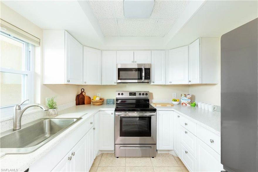 New 4-piece stainless kitchen appliance package! Wrap-around storm protection (new windows in 2016, storm shutters on the lanai) are just two of the important features offered with this two bedroom, second floor unit, accessible by elevator and stairs. Additional upgrades include an updated kitchen with Corian counters and single-basin stainless sink, updated bathrooms, a new A/C system in 2016, new A/C handler in 2022, new hot water tank in 2021, with a newer washer and dryer, updated fans, new lighting fixtures, updated window coverings including Hunter Douglas blackout shades, and new, paddle-style door handles have replaced the '70s knobs. Country Club Manor, designated for residents who are 55+, has a beautiful pool area and tropical-style clubhouse, plus: all new roofs for the community, and is only fifteen minutes from downtown attractions and Naples white-sand beaches. This complex is near public golf courses, and is in a part of Naples that's enjoying redevelopment with new restaurants, grocery stores, and services for other lifestyle and daily needs.