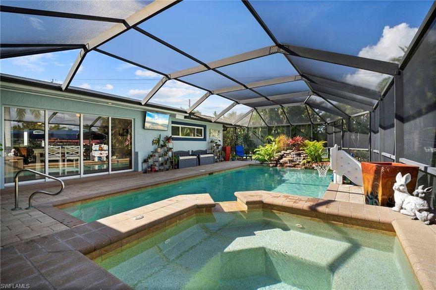 Price adjustment! Canal waterfront Gulf Access living in Cape Coral at it's finest! This tranquil 1,499 square foot 3 Bedroom 2 Bath Oasis is the definition of leisurely indoor-outdoor living. No fear of the water with the flood barriers and concrete block construction. From the resort style retreat in the backyard with the heated salt water pool and spa, 1 year old elevated Generac generator (transferable maintenance plan) and accompanying 500 gallon buried propane tank, 2 year old 4 ton AC, to the 2020 tile roof, you can sleep peacefully in your home, enjoying the best of water-side living with no worries about weather.
When stepping inside this home you'll be welcomed by beautiful tile floors throughout the home and a light and bright feel. The kitchen has gorgeous mocha cabinets, a spacious island, marble countertops and modern appliances, perfect for entertaining and meals by the Lanai, with stainless steel appliances that are less than 2 years old. The primary bedroom overlooks the lanai, has a HUGE custom walk-in closet and is accompanied by a beautiful, open bathroom with a SPACIOUS shower, gorgeous counter tops, and dark cabinets also accented by the light and bright paint. The garage houses the charcoal water filtration and softener system, room for the flood barriers and an additional fridge, and built in cabinets. This home has great natural light provided throughout thanks to the home having a south eastern water front view.

As you step through the sliding glass doors leading you to the screened in, paver pool lanai you are welcomed by a gorgeous in ground heated pool and spa accompanied by a stunning water feature flowing back into the pool sure to impress any guests. The pool has a roll out pool cover and over looks a stunning SE Cape Coral gulf access canal. Moving into the fully fenced backyard for your furry friends, you'll find the firepit area and the dock. The dock has a covered boat lift and a well-lit spacious dock area, with water and power and a 10,000LB lift. The backyard is accompanied by a shed for storage and plenty of space for pets and family/friends to enjoy the views and company.

Additional features for this home include a whole home Generac generator, Dam easy flood barriers, stunning landscaping and plenty more. This home is ready for its next owner looking for their slice of SWFL paradise. Act now before it's too late!