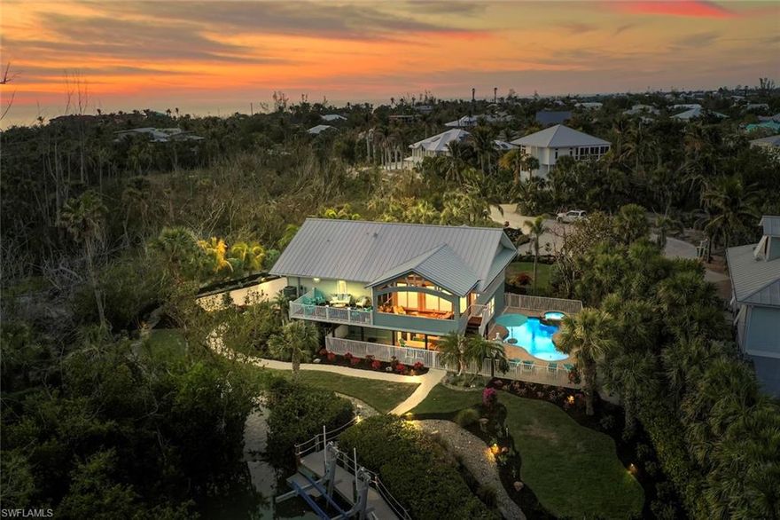 TRULY A BOATER'S PARADISE....Nestled along the serene shores of Dinkins Bayou, this stunning coastal retreat offers the perfect blend of luxury tranquility along with island adventure. Enjoy breathtaking long water views from your private inlet, complete with two boat lifts and a private kayak launch with direct access to the Bay and Gulf in minutes. If you prefer the beach, it’s only a short 5 minute walk to one of the best shelling beaches in the world. After a day on the water or at the beach, unwind in the sparkling heated pool and spa, or entertain effortlessly in the expansive outdoor living areas, featuring both screened and covered patios + an open deck to soak in the island breeze. Inside, the home is built for comfort and style. It features a cozy, open floor plan with great room and dining that spills out to the expansive screened lanai. The kitchen opens to the great room making it the perfect home for entertaining. Highlights include, gorgeous hardwood flooring throughout, plantation shutters, vaulted ship-lap ceilings, updated kitchen and baths and beautiful coastal decor. The primary suite opens to the screened porch, so you can have your morning coffee and enjoy the stunning sunrises. Bonus storage space off the pool deck further expands your entertaining space. Built with quality materials for the SWFL climate, this home features impact windows and doors, a newer metal roof (2022) and a composite boat dock complete with power, water and two boat lifts. When you're ready to explore, you can avail the many opportunities of waterfront living on a coastal island - launch your kayak or paddleboard from your own private launch - take a short walk to the pristine Gulf beaches for sunning + world-famous shelling or magical sunsets - cycle the islands 26+ miles of contiguous bike paths - or enjoy the vibrant dining and shopping of Captiva, all just minutes away. This is the ultimate Sanibel lifestyle—where coastal charm meets effortless waterfront living. Don't miss this rare opportunity to own a slice of paradise!