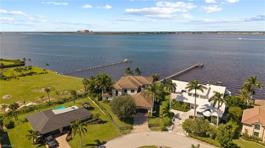 LUXURY RIVERFRONT LIVING. Custom Carlton-Naumann 6,394 Sq. ft. masterpiece, where a rare opportunity with unobstructed water views awaits you. Expansive pool and new 320-foot dock, Boat lift and space to fit multiple boats, perfectly positioned on the CALOOSAHATCHEE RIVER. 6 Bedrooms, Den, Study and 6 Bathrooms & pool access. Every inch custom designed to showcase panoramic water views and sophisticated coastal elegance. Step inside to soaring ceilings and seamless indoor-outdoor living spaces that frame the stunning River backdrop. Open-concept great room flows effortlessly into a Quartz & Granite kitchen, featuring top-of-the-line appliances, custom cabinetry and a grand island ideal for entertaining. Underground propane tank services kitchen cooktop, Pool heat, outdoor kitchen and Fireplace. Equipped for whole house generator. Impact glass throughout. Retreat to a lavish suite, featuring a private terrace overlooking the river, spa-inspired bath and grand walk-in closet. Multiple guest suites offer privacy and comfort for family, friends and guests. Outside you will enjoy the ultimate Southwest Florida lifestyle with a resort-style pool, expansive covered lanai, outdoor kitchen and private dock, perfect for boating, fishing, water sports and sunset cruises. Located just minutes from the vibrant Downtown Fort Myers River District, fine dining, shopping and beaches, this gorgeous property blends tranquility with convenience. From sunrise to sunset and evenings by the pool, this is more than a Home. It is Paradise...on the RIVER.