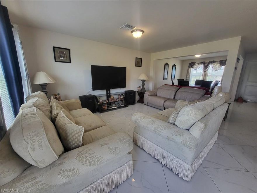 This home is in a quiet NW Cape Coral neighborhood surrounded by new construction homes. This large family home is over 2000 sq ft, built in 2018, with 4 bedrooms and 2 and 1/2 baths and a 2 car garage. Large eat-in kitchen, formal dining room and large yard with plenty of room for a pool. All bedrooms are upstairs with a large master with huge walk-in closet and the other bedrooms are good sized as well. There is a 2nd floor laundry room. 1/2 bath downstairs for guests. Beautiful new large tile on first floor. Interior needs cosmetic updates. Home had exterior siding damage from hurricane Ian and is being sold As-Is only.