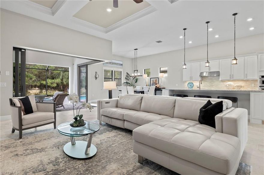 FULLY FURNISHED-Step into luxury as you explore this meticulously crafted Pinnacle Floor Plan, spanning 2,488 sqft and built in 2019. This home features 3 bedrooms + Den, and 3 Full Bathrooms. The spacious and meticulously kept living area offers an inviting ambiance, Newly painted Interior, creating the perfect setting for both relaxation and entertainment. At the heart of the home is a culinary masterpiece – a white kitchen adorned with an induction cooktop and a custom-built pantry, ensuring both style and practicality. Walk through the Zero Corner Sliding Doors and the your outdoor private haven, complete with a brand new outdoor kitchen and a heated pool, all surrounded by private preserve view. Brand New fabric storm shutters in the lanai, providing both security and aesthetic appeal. The large owner’s suite is a sanctuary of comfort, featuring dual sinks, closet with custom-built-ins, and a serene atmosphere.  Your Guests will enjoy a private suite in the front of home that adds an extra layer of convenience. The three-car garage, with an epoxy floor and a split AC unit. Set in the amenity-rich community of Corkscrew Shores, this residence is a testament to refined living.