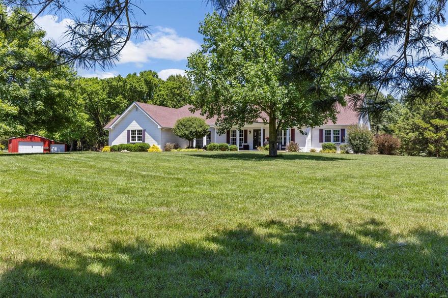 Private oasis on 5 acres surrounded by beautiful landscaping, mature trees on a gorgeous wooded lot with salt water pool & Tiki bar. Home has classic features with abounding updates. Walking /ATV trails & a walking bridge leads to a shared pond.Property backs to 100+/-acres of undeveloped land/farm land. Outbuilding w/water & electric w/custom party area & utility building.Main floor features a chef's kitchen w/gas stove, large island, wood beam ceilings. Open concept living area w/dining room & great room w/stone 2 sided fireplace.Large home office/additional bedroom with closet. Divided floor plan features 2 main floor bedroom suites. Primary bath is renovated w/stand alone tub & custom shower.Walk out to the deck overlooking the pool from the primary bedroom. Large mud room/drop zone w/writing desk & laundry. Upper level has 2 beds w/ Jack&Jill bath. The home has been updated w/ stylish neutral decor. Zoned HVAC.Oversized 3 car garage. 3 acres of pet fence. Minutes from Hwy 70 & 61. Additional Rooms: Mud Room