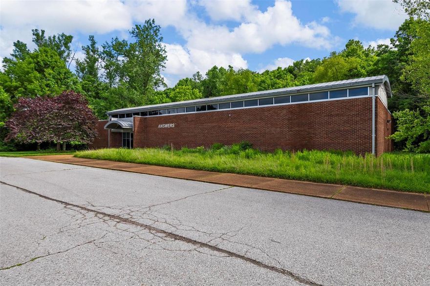 Extraordinary commercial property conveniently located in West County on 3.9 acres. Interior design includes vaulted ceilings, exposed beams, and tons of natural light. The entry way boasts an exceptional reception area that can be re-configured as an open concept space. Left of the reception there is a large conference room and two private office spaces. The right side of the building features several large spaces that can easily configured to your business' needs. Also included is two storage rooms.  The back of the building is completed with a kitchenette, two large bathrooms, and a copy room with plenty of storage. This lot offers abundant parking for visitors and staff alike! Location: Suburban