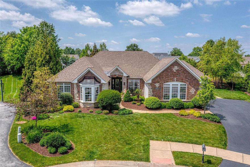 Spectacular brick & stone ranch home beautifully designed & stylishly appointed to accommodate daily comfort & gracious entertaining. Impressive entry foyer leads to private study, elegant dining room with domed ceiling & stunning great room with wall of windows. Exceptionally large kitchen featuring knotty alder cabinetry, granite countertops, Viking appliances & double islands adjoins breakfast room with wet bar & vaulted hearth room highlighted by floor-to-ceiling stone fireplace. Coffered primary bedroom suite with luxury bath with linear fireplace & shower spa offers an appealing retreat. A 2nd bedroom & hall full bath complete the main floor living quarters. Just completed—Lower Level entertainment space with recreation room with fireplace & built-in bookcases & game room with gathering bar plus workout room & 2 ensuite bedrooms. Outdoor living area includes covered patio, grilling station, full-height fireplace & resort style pool with waterfall surrounded by landscaped gardens.