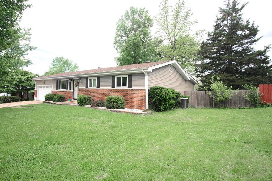 Wait until you see the inside.This 3 bedroom, 2.5 bath home w/2 car garage. Open living room with natural lighting opens into an amazing kitchen featuring granite counters, under cabinet lighting, newer cooktop and wall oven. Wood floors throughout upper level,  Master bedroom features an bonus room separated by a chic barn door that can be used as a large walk-in closet, dressing/makeup room, or office. The master bedroom also has a full bath with access to private patio in the backyard. The other 2 bedrooms and hall bath round out the main level. In the lower level you will find a mostly finished space with large family/media room with a wet & dry bar, and half bath. The fenced backyard is perfect for family gatherings with a covered porch great for grilling, and beautiful landscaping. Home has had many updates throughout in recent years and is ready for you to enjoy! This home is minutes from highways 364, 94, 70, & 64, major shopping, and entertainment venues.