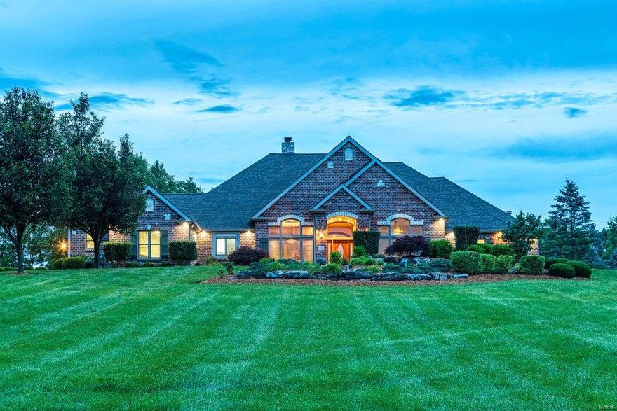 Spectacular brick & stone Estate home on 3 scenic acres. Impressive entry foyer with gallery staircase leads to elegant dining room & stunning great room with floor-to-ceiling brick fireplace & French doors that open to expansive deck. Designer kitchen with glazed cabinetry, granite countertops, commercial grade appliances & butler’s pantry adjoins light-filled sunroom, octagonal breakfast room with wide bay window and hearth room highlighted by brick & stone fireplace. Coffered master bedroom suite radiates warmth with a brick fireplace, sitting room & luxury bath with jetted tub. A 2nd ensuite bedroom completes the main floor living quarters. Open staircase accesses Lower Level entertainment space with recreation room with stone fireplace & wet bar plus office, workout room, 2 additional bedrooms with Jack n’ Jill bath, guest suite & ½ bath. Grounds include landscaped gardens, waterfalls & 3-car garage. In addition, the property features a 52’ x 40’ detached garage with bonus room. Additional Rooms: Sun Room