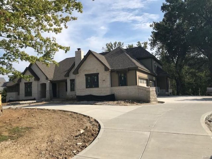 Meet the “Editorial” Flower Home’s new Custom-Designed Ranch which will be ready mid-November. The Gathering Room, with 11’ architectural ceilings, a wall of windows, brick and stone fireplace, is open to the chefs kitchen and is the heart of the home. The coffered Master Suite features his and her baths.  Vaulted beamed ceilings enhance the Library and the Corner Retreat which also has a brick/stone floor to ceiling cozy fireplace. A private staircase leads up to the Studio Suite. The walkout lower level, with 3 sets of French Doors, Recreation Rm, Game Rm, Exercise Rm, Wet Bar Area and 4th Bedroom Suite, walks out to a park-like private backyard perfect for a pool. There is a 4-car side garage, circle drive, 3 covered porches, 41’ x 14’ deck, built-in vac, Thermodor appliances, custom cabinets and so much more. Come see for your self.