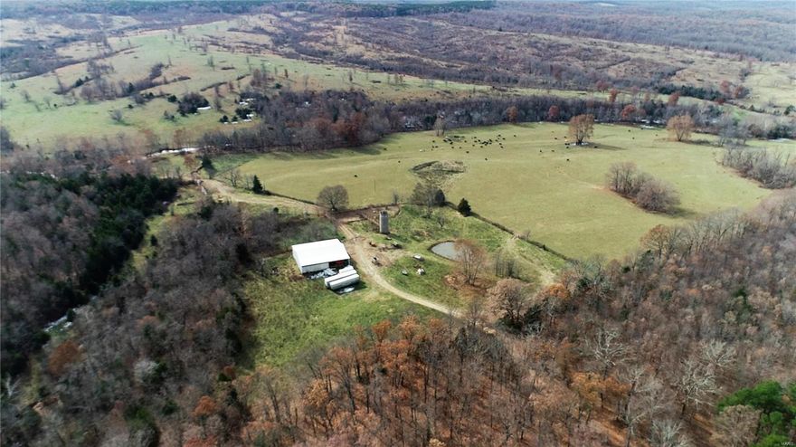 Drone video available at https://youtu.be/OJow7-9yi2g. Improved price. 915 +/- acres of prime pasture or recreation land with plentiful water in East Central MO that borders Mark Twain National Forest. Located in the Meramec River Watershed. Water includes a section of the East Prong of Crooked Creek. Property is fenced & cross fenced. 64x70 pole barn for hay/feed/equipment. Cattle corrals. Multiple productive hay fields.  Year round water & abundant wildlife would make this great recreation land for the avid sportsmen.  100-150 cattle pair sustainability. Includes 5 parcels of land priced at $1081/acre.
