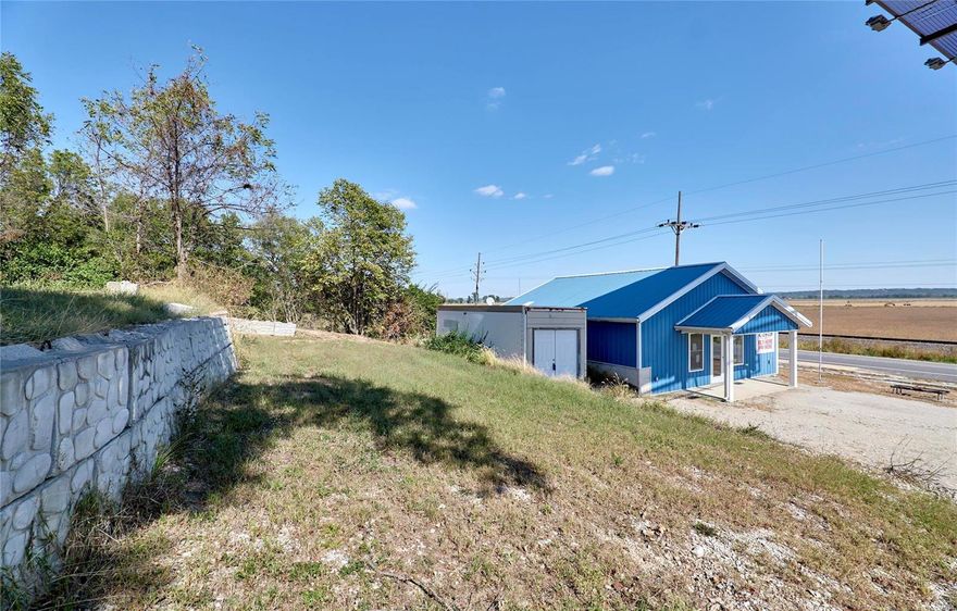 High Traffic Visibility Commercial Property! Great Investment Opportunity! Newly Updated building that is versatile and room to expand. Previously used as a Car Lot/office space.  This property is also suitable for: Office/General, Office Showroom, Professional Services, Retail Operation, Hair Salon and so much more. Building could also serve as a Primary residence.  At just under 1000 sq. ft. The Building offers a full bath and partial kitchen area. Two private rooms/ office areas, two large storage closets and A Large open space with plenty of natural light.   With .5 acre there is plenty of land to add storage units/buildings and lease the building to generate income.  Newer Septic .Currently on a 50 gal Cistron. Storage Unit just behind building stays.  Property and building sit directly on Highway 79 with High traffic counts  and IS NOT in the Flood plain. You do not want to miss your chance to own this one! Location: High Traffic, Hwy/Interstate Frntg