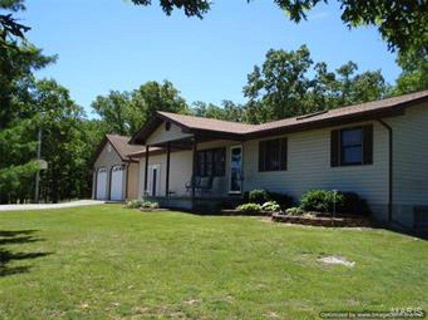 3 Bedroom, 2 bath ranch home with large 2-car garage connected to the house by an enclosed breezeway.  Has a 10x62 patio with access from the kitchen and from the master bedroom.  New roof on house in 2015.  There is a 12x20 building with electricity and a 12x24 cabin with a 6' porch..  10.56 acres m/l partially wooded with some mature trees.  Agent owned.