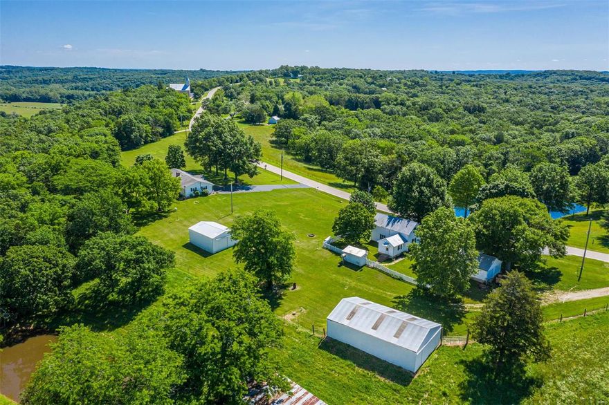 STUNNING VIEWS! 2 homes on almost 40 acres! Close to 44 and just 30 minutes from West County! The original farm house has lots of character and currently tenant occupied. The main residence has 3 large bedrooms, wood-burning fireplace, main floor laundry, a full basement with second kitchen, and all in immaculate condition! Property has fencing, outbuildings/barns, small pond, and has been used to raise animals in the past. You MUST SEE the view in person! Lots of road frontage left and would make a great building site for a new home! Call for your private tour today!
