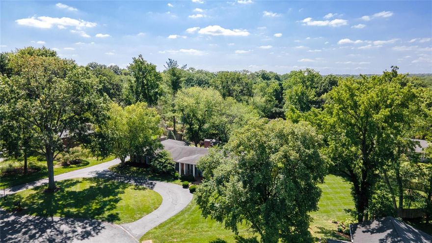 BACK ON MARKET.  NO FAULT OF SELLERS!  GREAT OPPORTUNITY TO LIVE CLOSE TO SCHOOLS IN THE LADUE SD.  This stylish 4 bd, 3 full & 2 half bath ranch on .83 acres is the ultimate in indoor/outdoor living.  The lg liv and din rms with gleaming hardwd flrs give way to a light filled fam rm with built ins, wainscoting & gas fp.  The custom kitchen has been updated with stainless appliances, Wolf cooktop, hardwood floors and provides access to the beautiful patio and new covered living area with fireplace and TV.  The main floor master suite offers a walk in closet, and beautiful bath with double sinks and stand alone shower.  Find 2 bedrms that have access to an updated hall bath and another BEDRM SUITE is located on the other side of the 1st flr perfect for au pairs, guests etc.  A laundry rm with custom cubbies and half bath complete the 1st flr.  The expansive walk out low lev offers a walk behind bar, fam area with built ins and fp, a rec area, exercise rm and half bath.  Room for a pool! Additional Rooms: Mud Room