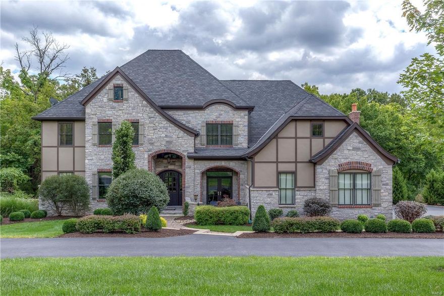 Exquisite Newer custom home on 1-acre private lot. Exceptional Exec Home with Open floor plan & uncompromised craftsmanship throughout. 1.5 story with 5 bedrooms & 6 baths. Soaring beamed ceilings, extensive custom millwork. 2 story foyer opens to study w/built ins. Private dining room has French door to patio opens to Butler's Pantry. Stunning Great room w/coffered beamed ceiling, arch stone pillars, wood flooring w/tile inlay, built ins, pass thru wet bar. State of the Art Kitchen, custom cabinets, Thermadore appliances, huge center island, sunny breakfast room, opens to vaulted hearth room w/gas FP. Coffered ceilings in Main floor master suite w/morning bar, refrigerator. Luxurious master bath with his/hers vanities, walk in closets. Upstairs has 3 bedrooms: 1 w/private bath & 2 w/Jack N' Jill baths plus a huge loft/family room. Finished walk out lower level has wine cellar, stunning bar/rec room, 5th bedroom w/private bath. 3 car garage. In the heart of Town & Country!