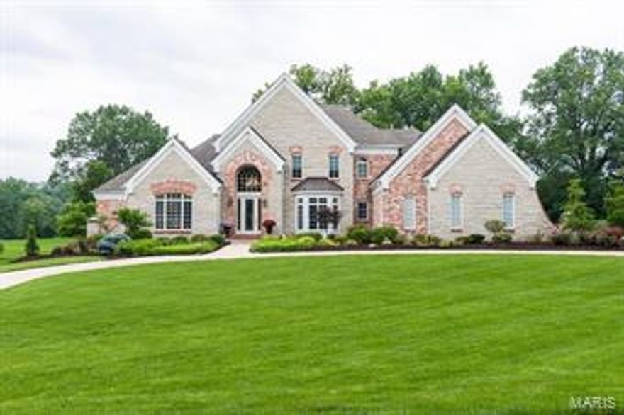 Exquisite 1.5 Sty brick & stone home with nearly 5800sf of living space! Grand 2-Sty marble foyer opens to an office with bay window & a built-in bookcase, spectacular 2-Sty great room with marble fireplace flanked by arched bookcases and an elegant dining room with extensive millwork. Fantastic kitchen featuring custom cabinetry, granite countertops, stainless steel appliances, center island with breakfast bar & adjoining breakfast room & hearth room with gas fireplace. Peaceful master bedroom suite with a door leading to your private backyard.  The LARGE master bath will WOW you with 2 walk-in closets and private shower. 3 additional bedroom suites are located on the 2nd level.  The Lower Level features a family room with gas fireplace, billiards room, Wet bar, exercise room & half bath. Professionally landscaped 1.75-ac grounds include expansive entertaining space & 4-car garage.