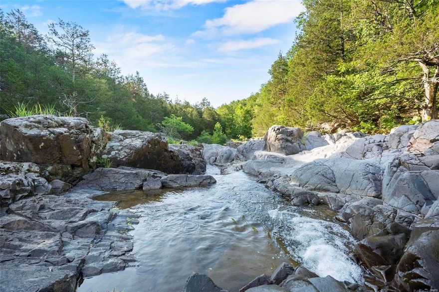 Located on a dead-end county road, this diamond in the rough is the home to one of Madison Counties most beautiful natural features, the Klondike. For over a decade, this property has been under an intense Habitat & Forest Management Plan. Here you will find everything an outdoor enthusiast & nature lover would desire. From the miles & miles of trails to major creeks & tributaries, 8 springs, restored glades, and over 50+/- acres in open ground at various stages of regrowth. This property is full of rich history dating back to the civil war & beyond. The property is equipped with an immaculately kept log cabin as well as a farmhouse perfect for a caretaker, rental, or guest house. There are multiple historical barns & equipment sheds. This property will be an AS-IS sale. There is an option to purchase this property in 206+/-, 161+/-, and a 100+/- acres, all with different offerings
